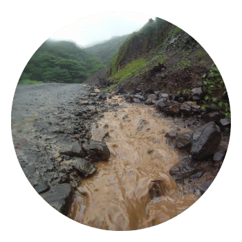 water running down road during rain 